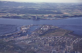 Oblique aerial view centred on the docks and oil refinery, taken from the SSW.