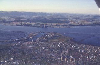 Oblique aerial view centred on the docks and oil refinery, taken from the SSW.