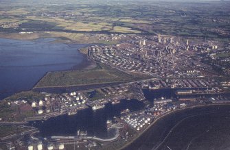 Oblique aerial view centred on the docks and oil refinery, taken from the NW.