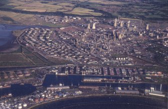 Oblique aerial view centred on the docks and oil refinery, taken from the NW.