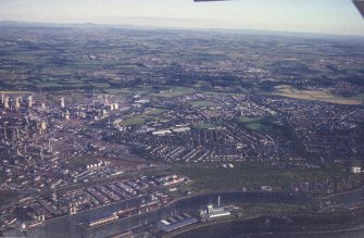 Oblique aerial view centred on the oil refinery and hangers, taken from the N.