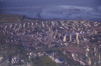 Oblique aerial view centred on the oil refinery, taken from the SW.