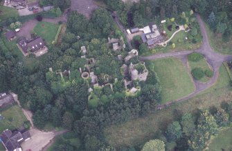 Oblique aerial view centred on the remains of the country house, taken from the SW.
