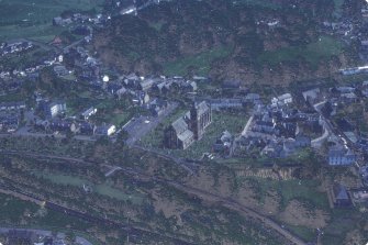 Oblique aerial view centred on the mine and buildings with farmstead adjacent, taken from the NW.