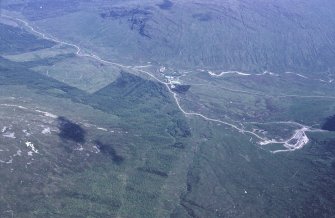 Oblique aerial view centred on the mine and buildings, taken from the NW.