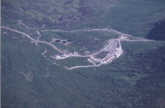 Oblique aerial view centred on the mine and buildings with farmstead adjacent, taken from the WSW.