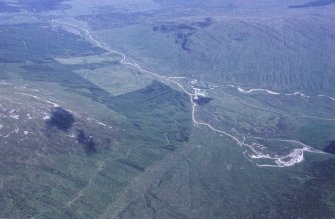 Oblique aerial view centred on the mine and buildings with farmstead adjacent, taken from the WSW.