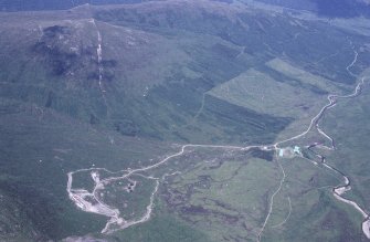 Oblique aerial view centred on the mine and buildings with farmstead adjacent, taken from the SW.