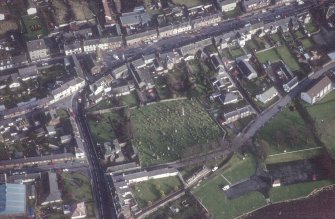 Oblique aerial view centred on burial ground from W.