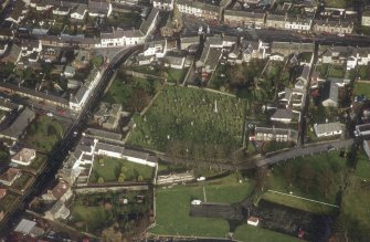Oblique aerial view centred on burial ground from W.