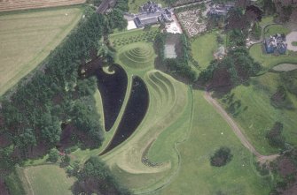 Oblique aerial view centred on the garden and country house, taken from the WNW.