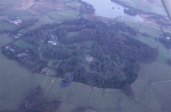 Oblique aerial view centred on house from SW.