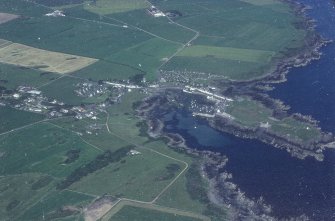 Oblique aerial view, taken from the SW, centred on the village.