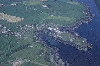 Oblique aerial view, taken from the SW, centred on the village.