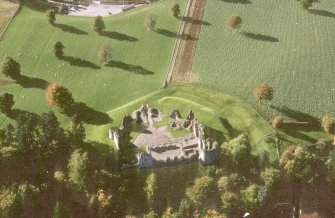 Oblique aerial view of Kildrummy, St Bride's Chapel and Well centred on the church with a possible motte and churchyard adjacent, taken from the NW.