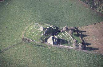 Oblique aerial view of Kildrummy, St Bride's Chapel and Well centred on the church with a possible motte and churchyard adjacent, taken from the NW.