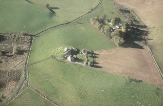 Oblique aerial view of Kildrummy, St Bride's Chapel and Well centred on the church with a possible motte and churchyard adjacent, taken from the W.