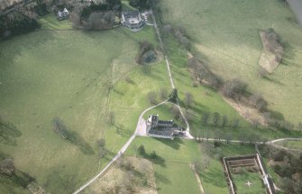 Oblique aerial view of the tower-house with walled garden adjacent, taken from the NNE.