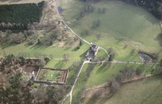 Oblique aerial view of the tower-house with walled garden adjacent, taken from the NNW.