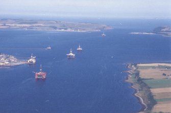 Oblique aerial view centred on the oil drilling platforms in the Moray Firth with Newhall Point and Invergordon harbour adjacent, taken from the W.