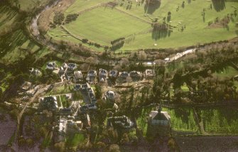 Oblique aerial view centred on Inveresk Gate, church and burial-ground, taken from the NNW.