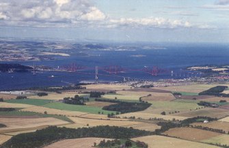 Oblique aerial view of the The Forth Bridge, Forth Road Bridge and South Queensferry from across the fields to the SW.
Also visible in the foreground is Duntarvie Castle.
