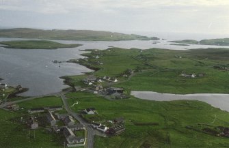 General oblique aerial view across the village to the island of Linga, taken from the NNE.