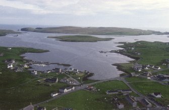 General oblique aerial view across the village to the island of Linga, taken from the NNE.