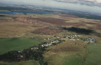 Tarbrax, oblique aerial view, taken from the SSE, centred on the village, with shale bings in the background.