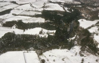 Oblique aerial view centred on Corehouse and power station with New Lanark adjacent, taken from the SE.