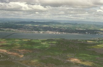 Oblique aerial view looking across River Tay, road and railway bridges towards the City of Dundee and Grampian mountains, taken from the SE.
