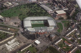 Glasgow, Parkhead, oblique aerial view, taken from the SW, centred on Celtic Park football stadium, and showing the Eastern Necropolis graveyard in the top half of the slide.