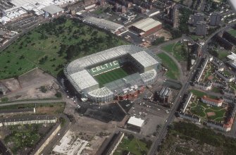 Glasgow, Parkhead, oblique aerial view, taken from the ESE, centred on Celtic Park football stadium, and showing the Eastern Necropolis graveyard in the top left-hand corner of the slide.