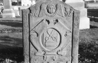 View of headstone to Robert Wat d. 1733 with tailor's tools, Monikie  Parish Churchyard.