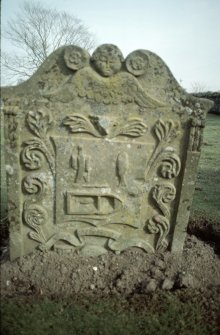 View of headstone to Amelia Paterson and 2 children 1761 with depiction of sock, coulter and boat, Kinfauns Parish Burial Ground.
