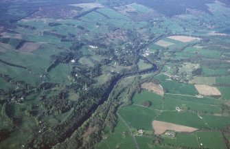 General oblique aerial view looking over Strathtay towards Pitlochry and the Grampian mountains, taken from the SW.