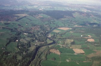 General oblique aerial view looking over Strathtay towards Pitlochry and the Grampian mountains, taken from the SW.