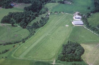 Oblique aerial view centred on the airfield and museum, taken from the ENE.