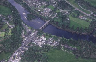Oblique aerial view centred on the town of Dunkeld with road bridge and cathedral adjacent, taken from the NW.