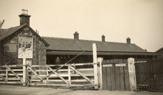 View from SW showing level crossing and station.