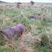 View of concrete filled iron barrels near concrete posts