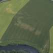 Oblique aerial view centred on the cropmarks of the Roman fortlet and ring-ditches, taken from the NW.