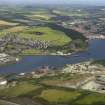 Oblique aerial view looking across Inner Bay with Inverkeithing, Dalgety Bay, quarry, paper mill, naval base mansions and pier adjacent, taken from the SW.