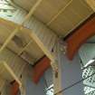 Interior. Detail of Belfast Truss roof showing the wooden braces and gusset boards securing the truss to the laminated timber wall posts and angle barcing struts.