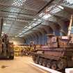 Interior.  Coupled General Service Shed showing Belfast Truss roof and central supports.  Shed in use for military vehicle repairs.