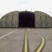 View.  Dispersal site showing modern hardened bombproof aircraft shelter with doors open from W.