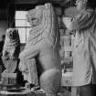 View of John Marshall carving one of the two gatepost lions for Pollok House, Glasgow, at Hew Lorimer's studio at Kellie.