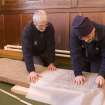 Interior. Mr J Borland and Mr I Parker making a rubbing of a Pictish cross slab