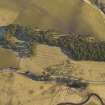 Oblique aerial view of the remains of the cultivation terraces, taken from the WNW.