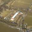 Oblique aerial view centred on the mill and the remains of the station, taken from the SSW.